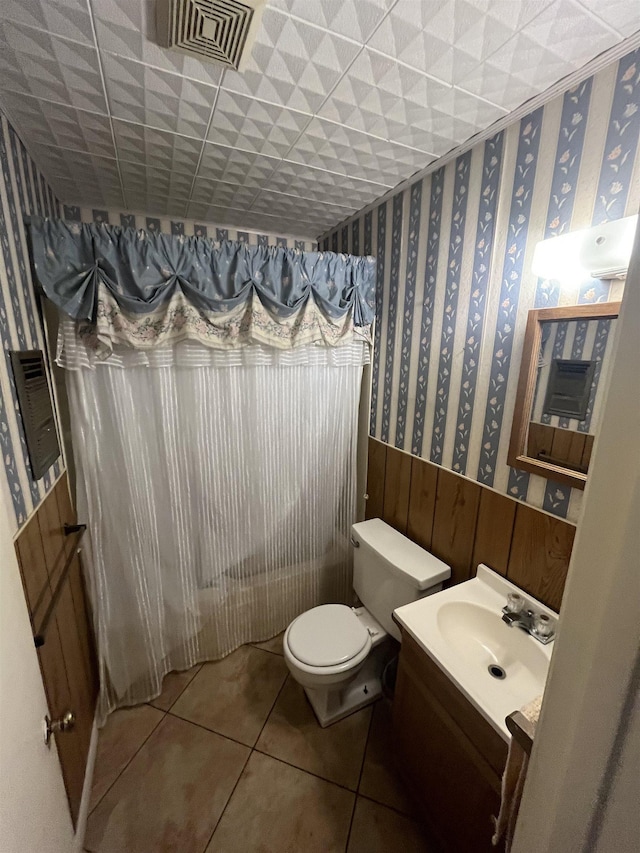 bathroom with tile patterned floors, vanity, and toilet