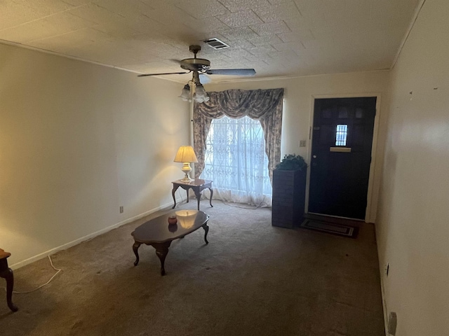 carpeted foyer with a textured ceiling and ceiling fan