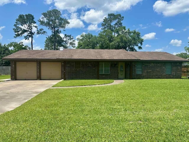 207 Lucky Dr, Silsbee, TX 77656 - ranch-style home with a garage, brick siding, concrete driveway, and a front yard