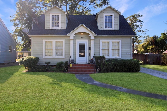 cape cod house with a front lawn