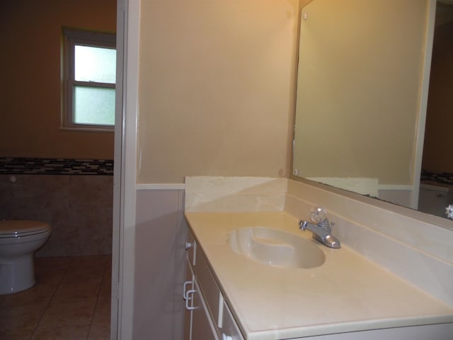 175 Isom St, Lumberton, TX 77657 - bathroom featuring vanity, tile walls, tile patterned floors, and a wainscoted wall