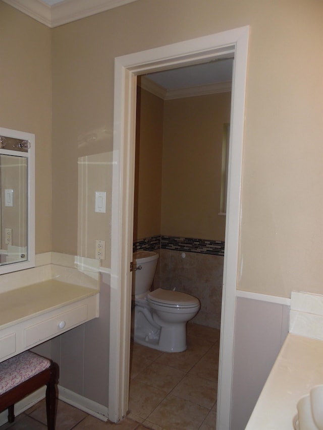 175 Isom St, Lumberton, TX 77657 - half bath with vanity, crown molding, tile patterned flooring, tile walls, and a wainscoted wall