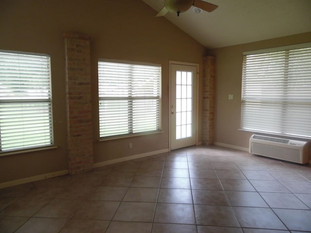 175 Isom St, Lumberton, TX 77657 - spare room featuring a ceiling fan, healthy amount of natural light, tile patterned floors, lofted ceiling, and an AC wall unit