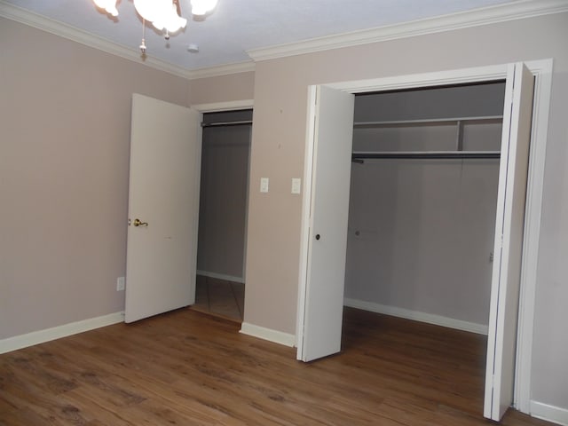 175 Isom St, Lumberton, TX 77657 - unfurnished bedroom with a chandelier, wood finished floors, crown molding, and a closet