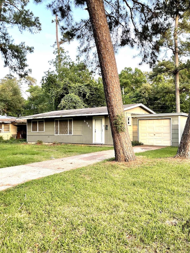 5335 Landry Ln, Beaumont, TX 77708 - ranch-style home featuring concrete driveway, a front yard, and a garage
