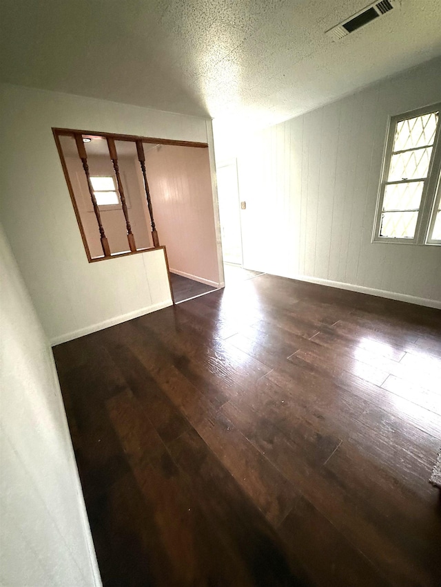 5335 Landry Ln, Beaumont, TX 77708 - unfurnished room with hardwood / wood-style flooring, a textured ceiling, and baseboards