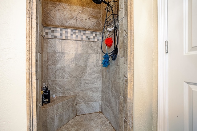 bathroom with a tile shower