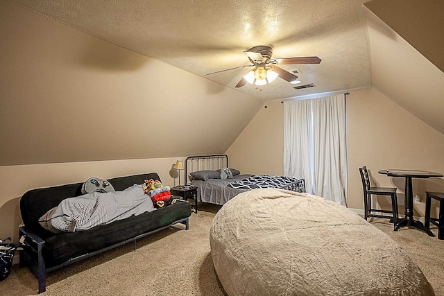 carpeted bedroom with ceiling fan, a textured ceiling, and lofted ceiling