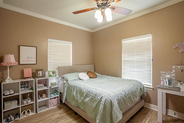 bedroom with ceiling fan, ornamental molding, and hardwood / wood-style floors