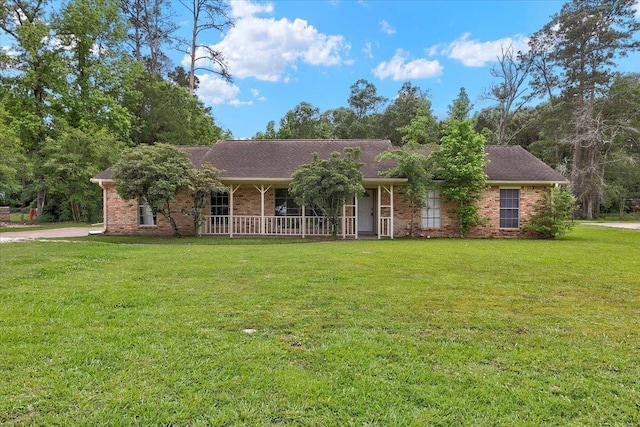 ranch-style house featuring a porch and a front lawn