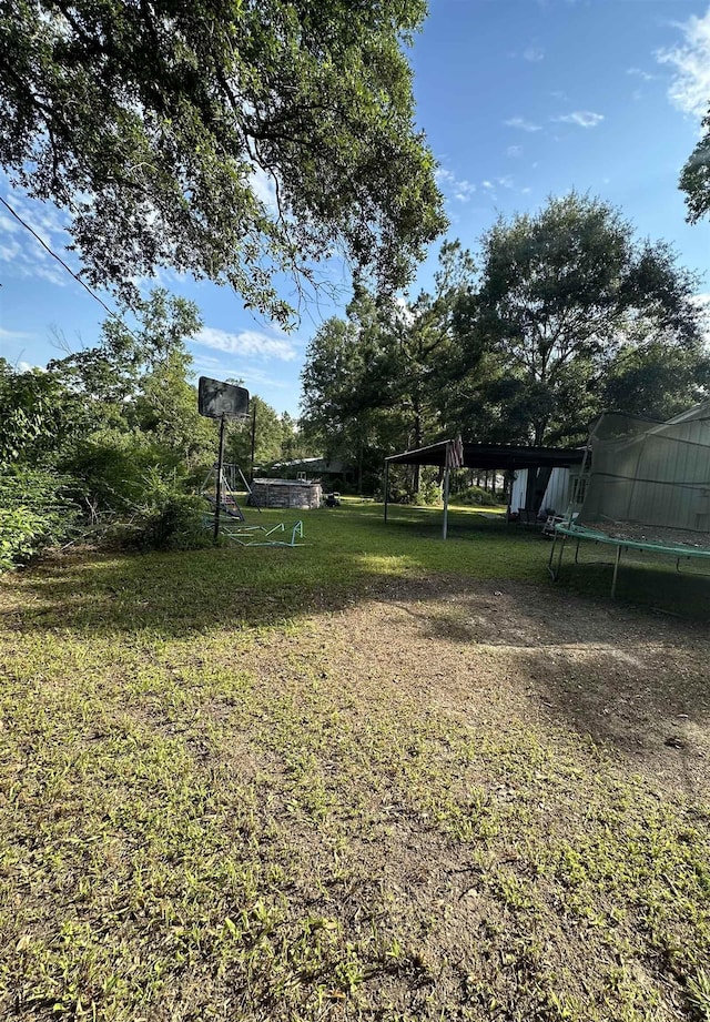 view of yard with a trampoline