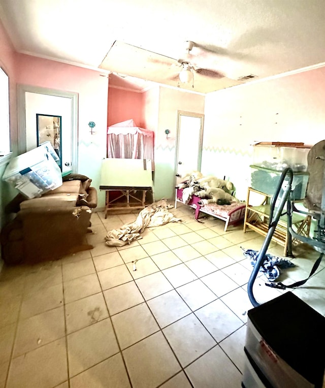 miscellaneous room featuring ceiling fan, crown molding, and light tile patterned floors