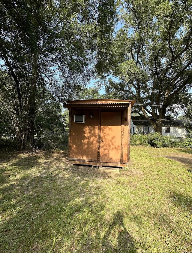 view of outbuilding featuring a lawn