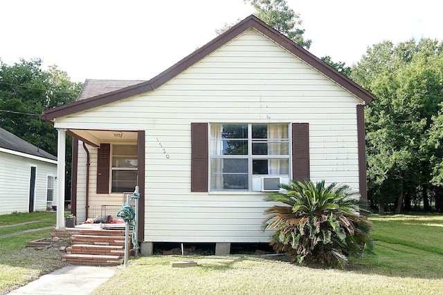 1720 Elgie St, Beaumont, TX 77705 - view of front of property with a front yard and cooling unit