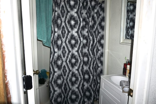 1720 Elgie St, Beaumont, TX 77705 - full bath with vanity, curtained shower, and a textured wall