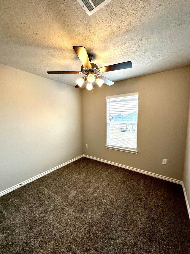 spare room with carpet floors and a textured ceiling