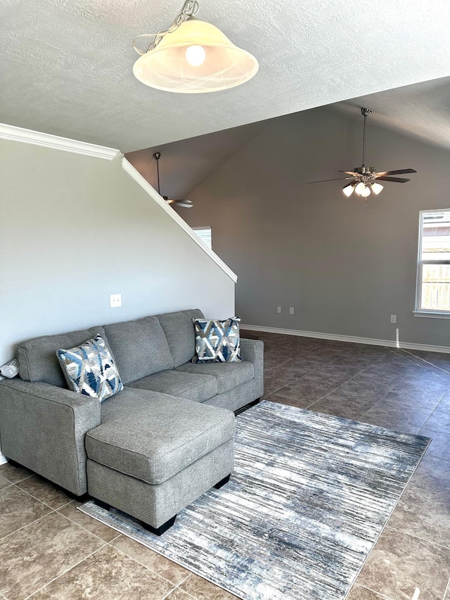 living room featuring a textured ceiling, ceiling fan, and vaulted ceiling