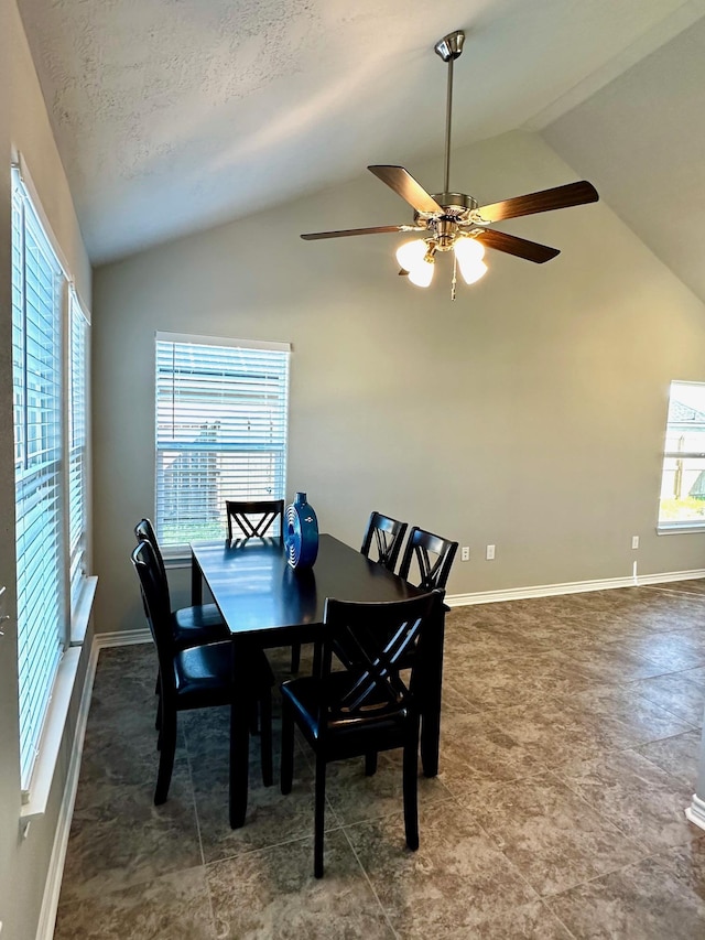 dining room featuring a textured ceiling, ceiling fan, and vaulted ceiling