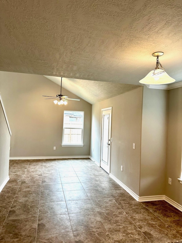 unfurnished room featuring a textured ceiling, ceiling fan, and lofted ceiling