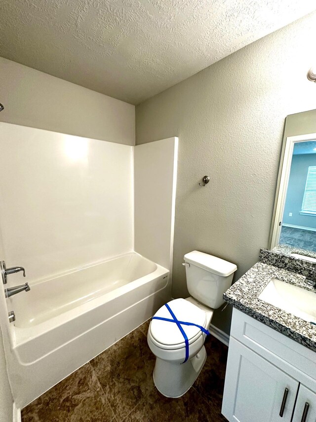 full bathroom with bathtub / shower combination, a textured ceiling, vanity, and toilet