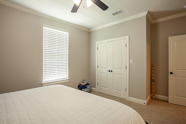3570 Mystic Ln, Beaumont, TX 77713 - bedroom with crown molding, carpet flooring, baseboards, a closet, and ceiling fan