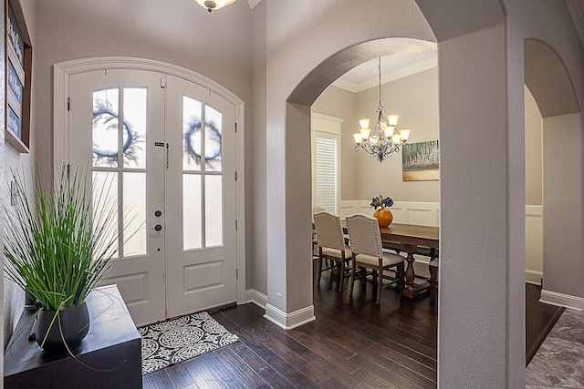 3570 Mystic Ln, Beaumont, TX 77713 - foyer featuring arched walkways, a chandelier, ornamental molding, healthy amount of natural light, and dark wood finished floors