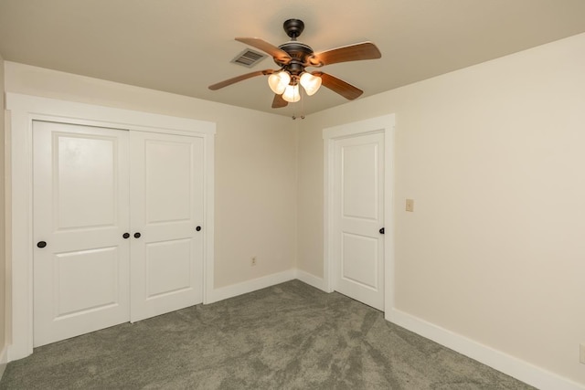 unfurnished bedroom featuring a closet, ceiling fan, baseboards, visible vents, and dark carpet