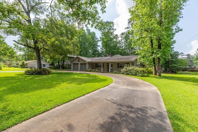 ranch-style house with a garage, a front lawn, and curved driveway
