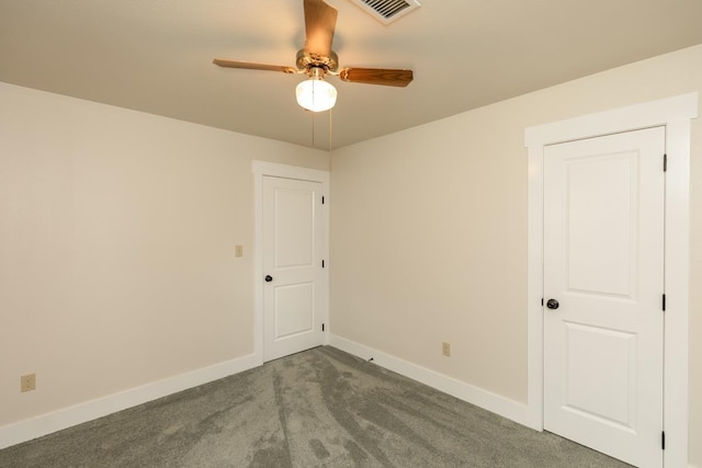 spare room featuring carpet, visible vents, ceiling fan, and baseboards