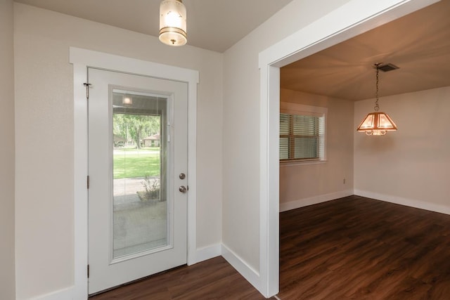 foyer featuring visible vents, dark wood-style floors, and baseboards