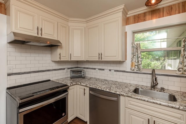 kitchen featuring a sink, under cabinet range hood, stainless steel appliances, tasteful backsplash, and a toaster