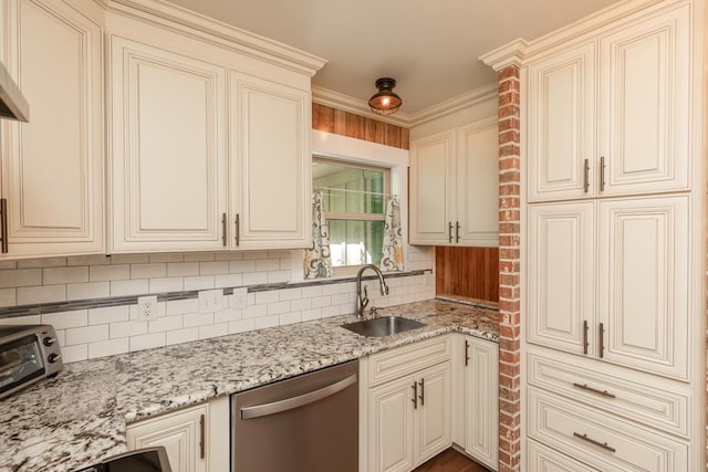 kitchen with backsplash, cream cabinetry, dishwasher, and a sink