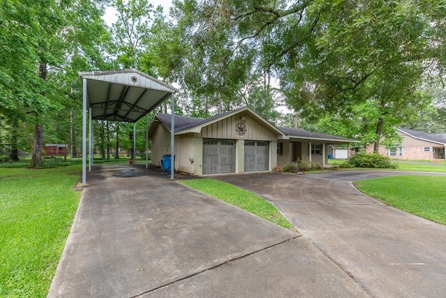 view of front of house with concrete driveway, a front lawn, and a garage