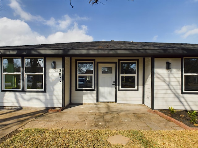 view of exterior entry featuring covered porch