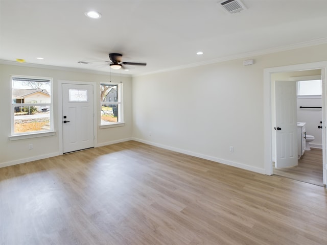 interior space featuring ornamental molding, a wealth of natural light, ceiling fan, and light hardwood / wood-style flooring