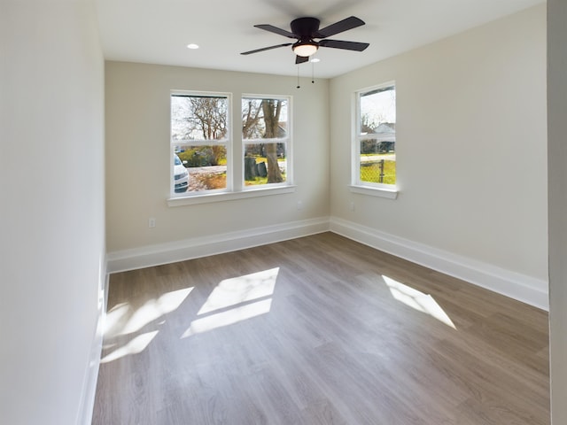 spare room featuring hardwood / wood-style flooring and ceiling fan