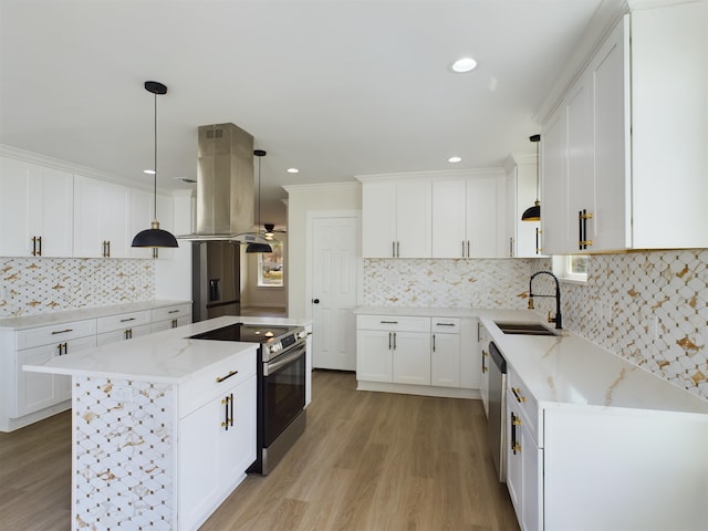 kitchen featuring sink, white cabinetry, hanging light fixtures, stainless steel appliances, and island range hood