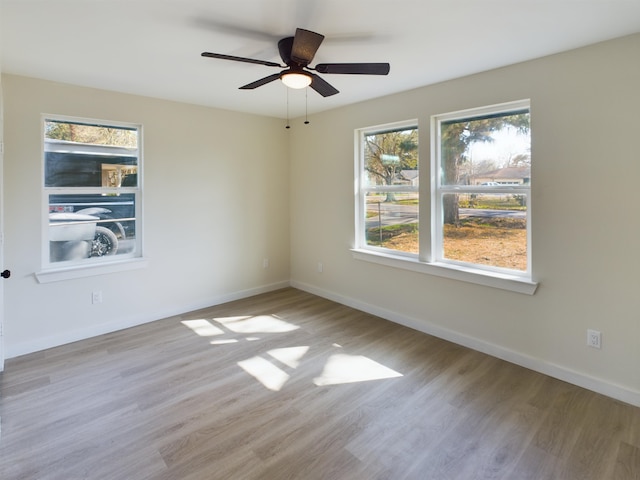 empty room featuring ceiling fan and light wood-type flooring