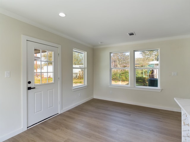 doorway featuring ornamental molding and light hardwood / wood-style flooring