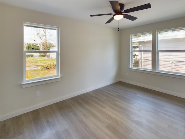 spare room with ceiling fan and light wood-type flooring