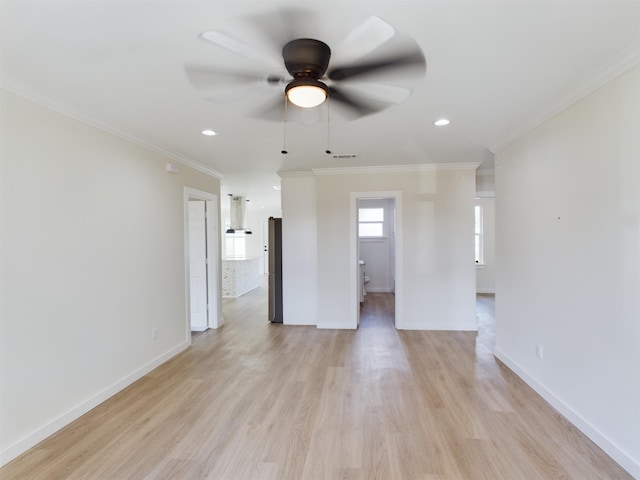 unfurnished room featuring crown molding, light hardwood / wood-style flooring, and ceiling fan