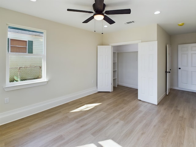 unfurnished bedroom with ceiling fan, a closet, and light wood-type flooring