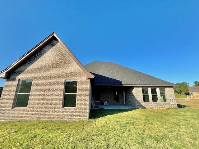 rear view of property with a lawn