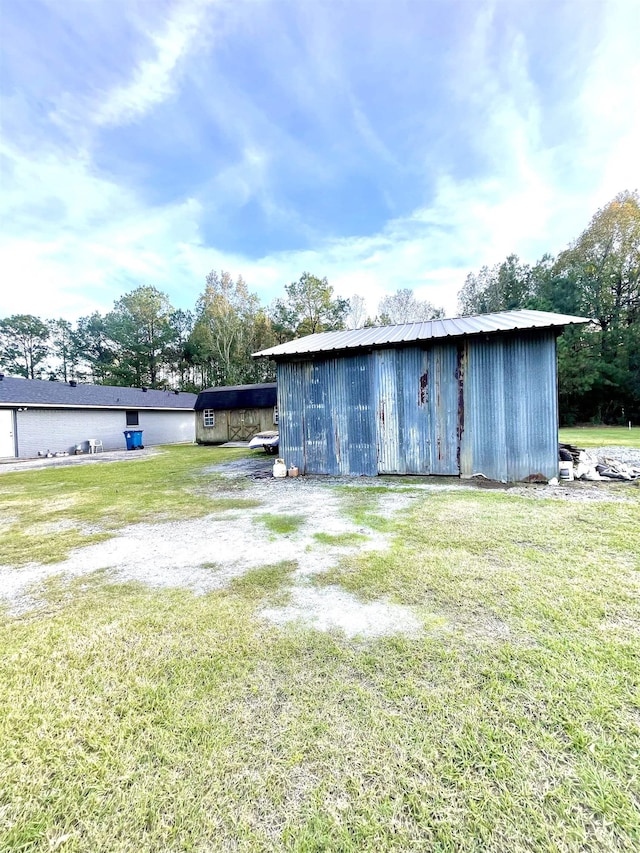 view of outbuilding featuring a lawn