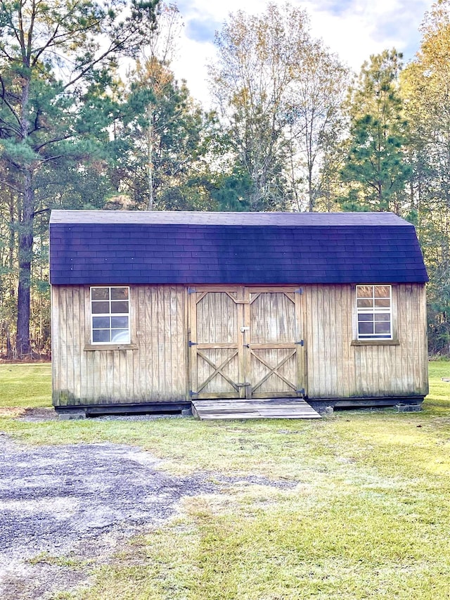 view of outbuilding featuring a yard