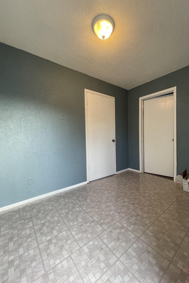 unfurnished bedroom with a textured ceiling and a closet