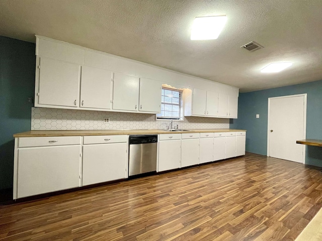 kitchen with hardwood / wood-style floors, dishwasher, white cabinetry, and a textured ceiling