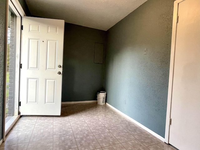 empty room featuring a textured ceiling