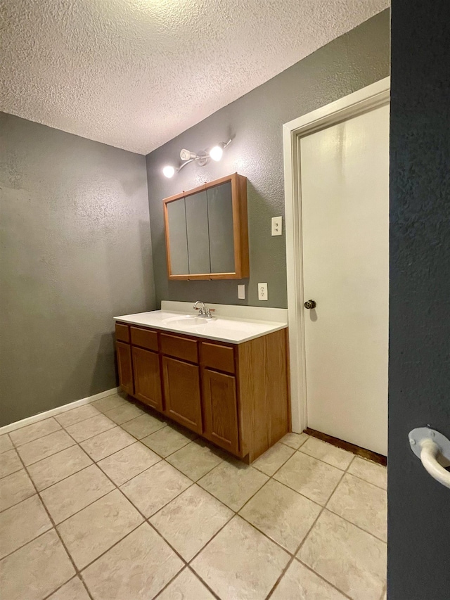 bathroom featuring tile patterned floors, vanity, and a textured ceiling