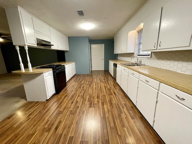 kitchen with white cabinets, black range with gas stovetop, and sink